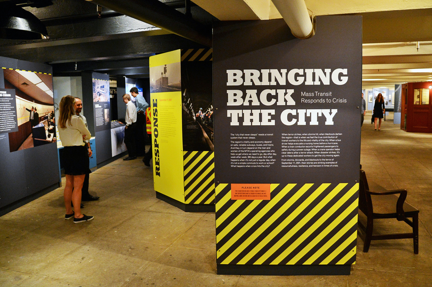 Visitors view Bringing Back the City gallery at the New York Transit Museum