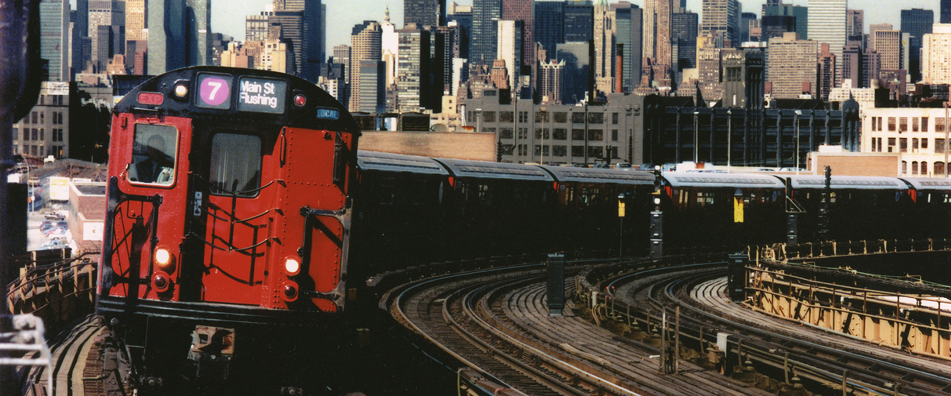 Redbird on Elevated Line with NYC Skyline