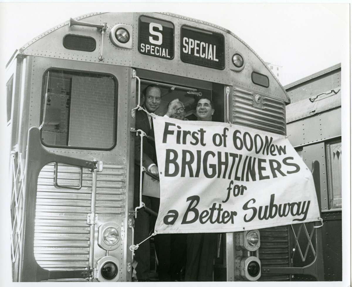 An R32 subway car with a banner reading "First of 600 New Brightliners for a Better Subway".