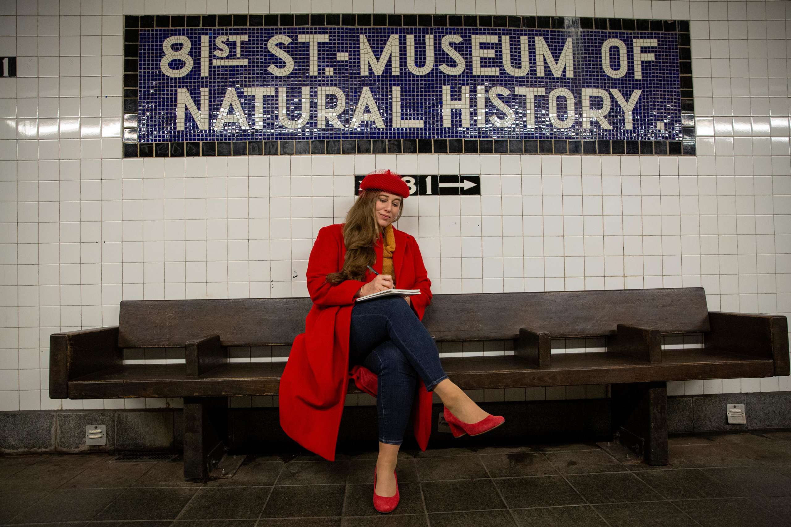 Author holding book on subway.