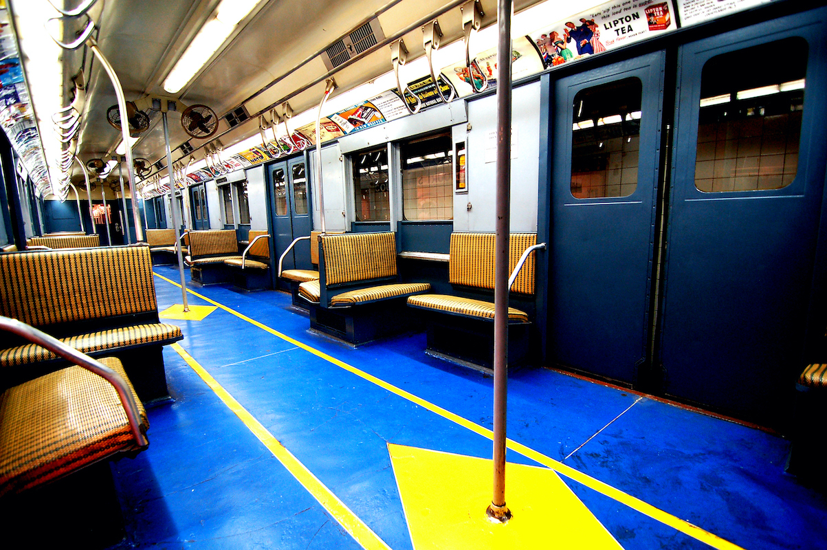 The inside of the IND R-7A car has a blue floor with yellow stripes and diamonds.