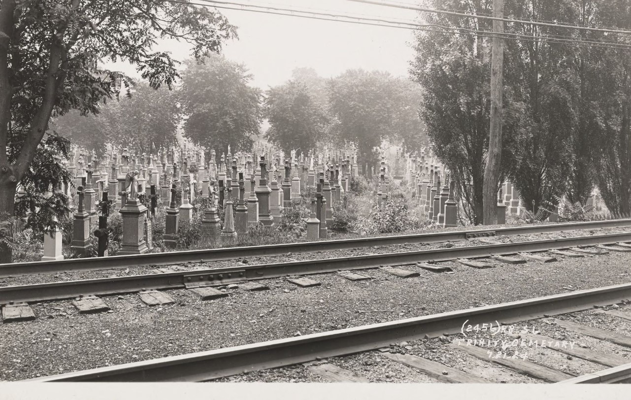 Railroad tracks in front of a cemetery