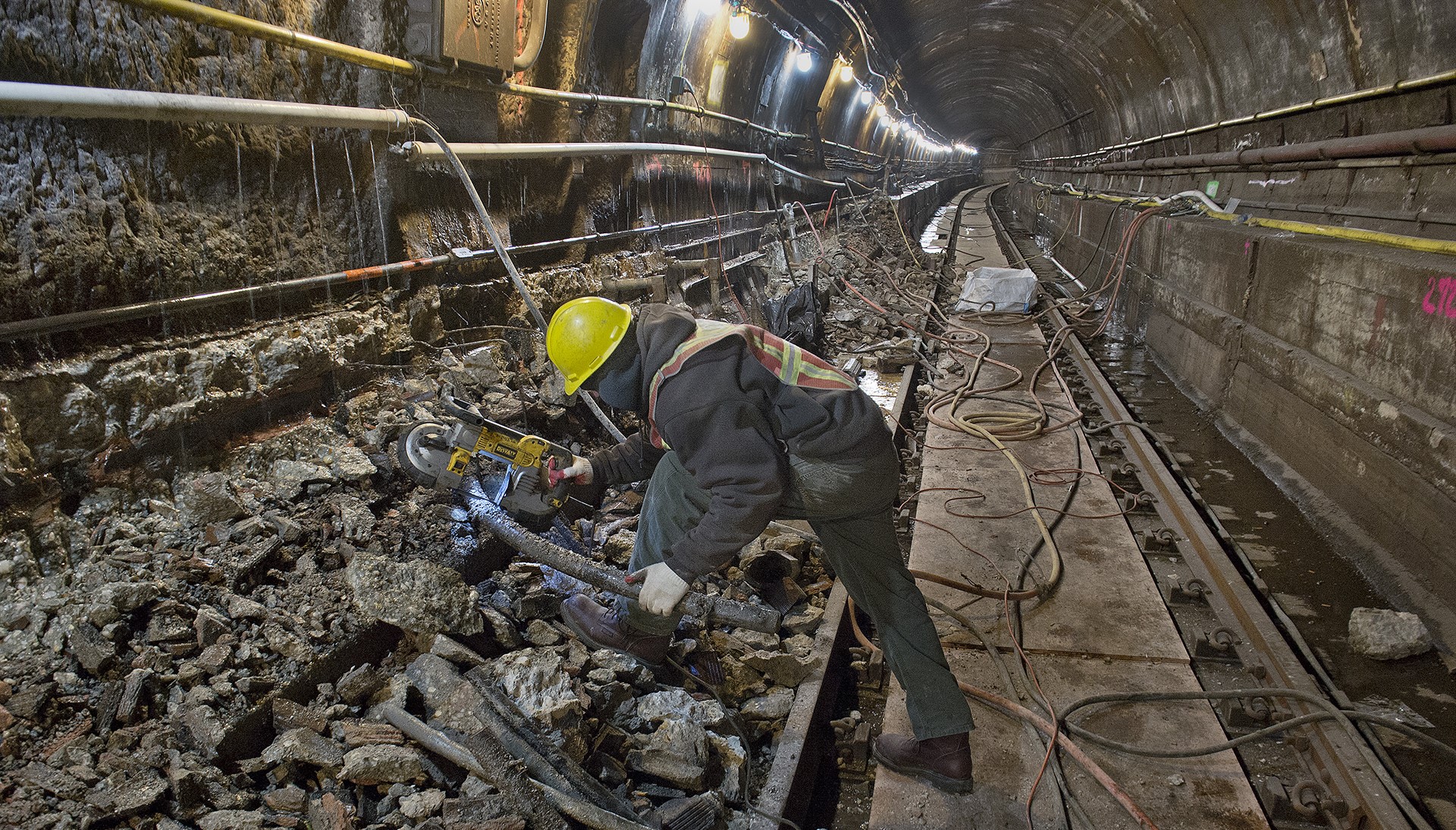 MTA worker removes debris in Montague tunnel