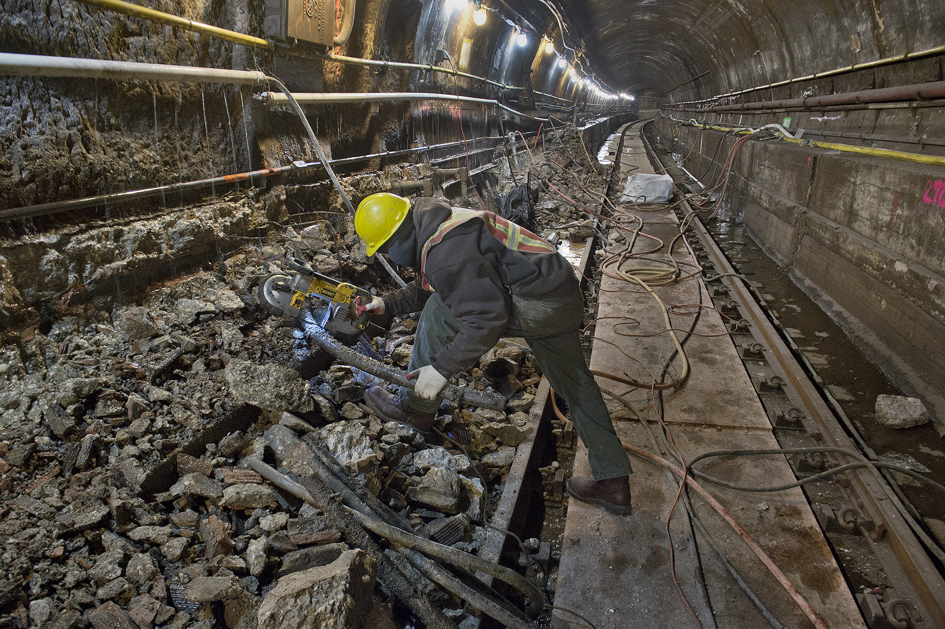 MTA worker removes debris in Montague tunnel