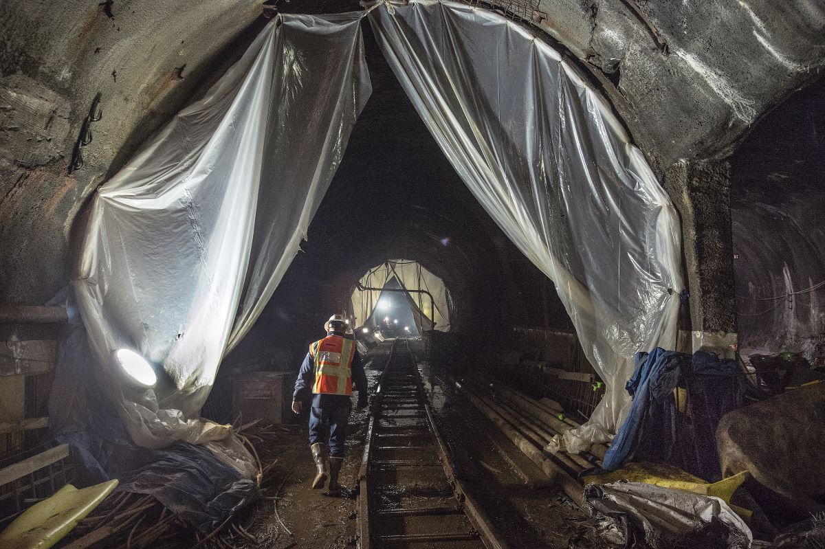 MTA NYCT Worker walking alongside tracks in East Side Access Tunnel during construction