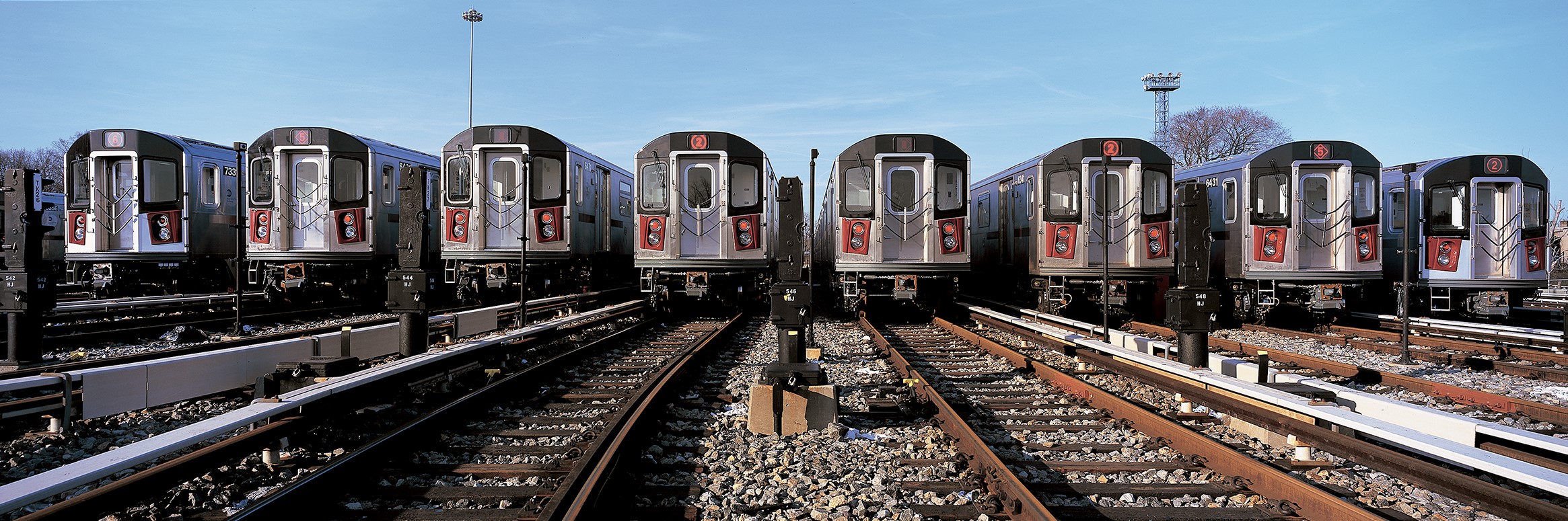 Line of subway cars in rail yard