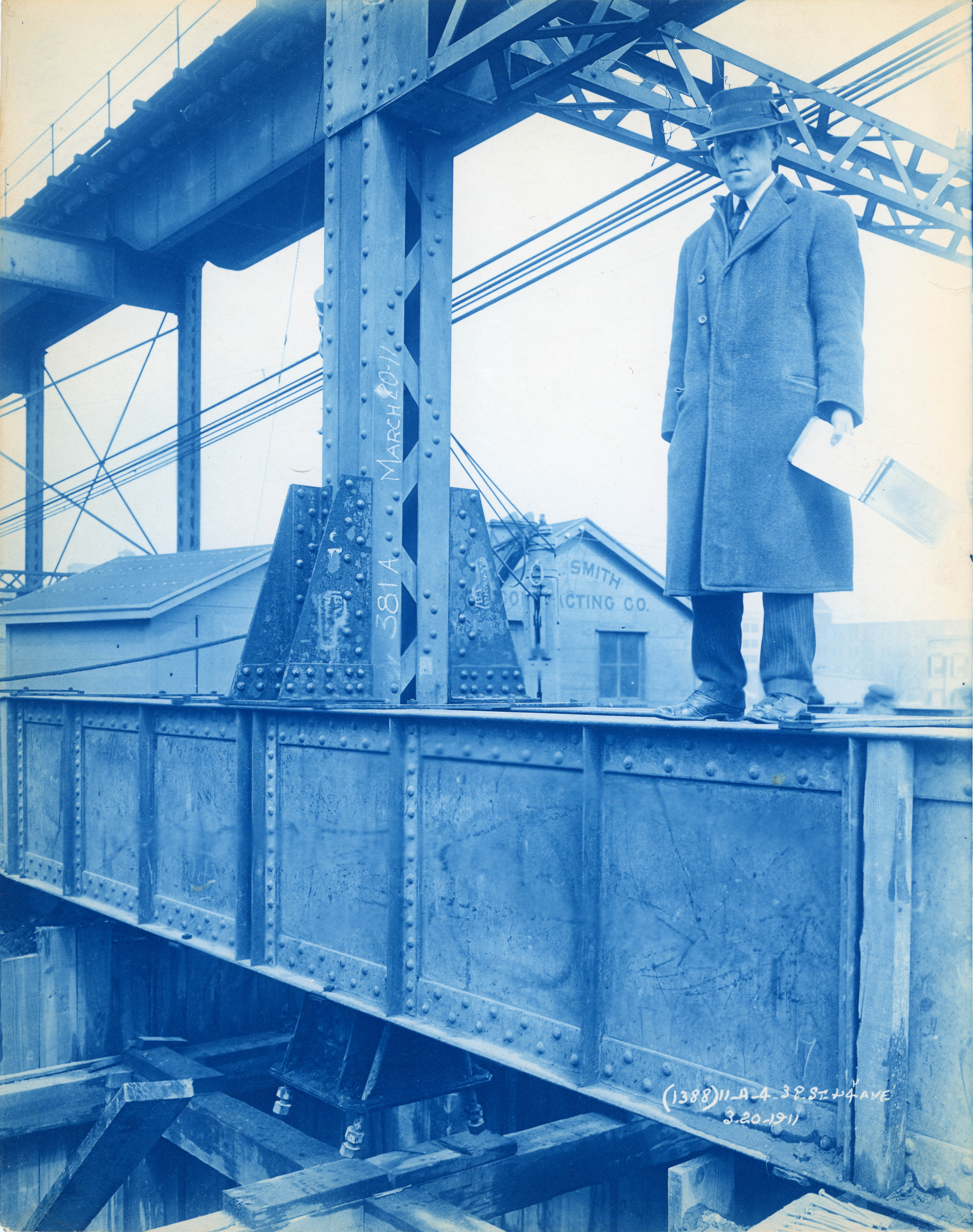 Man in suit stands on construction beam