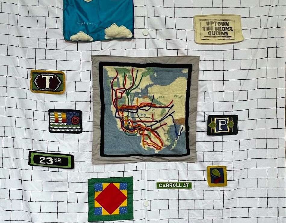 Fabric subway wall with maps, mosaics and signs