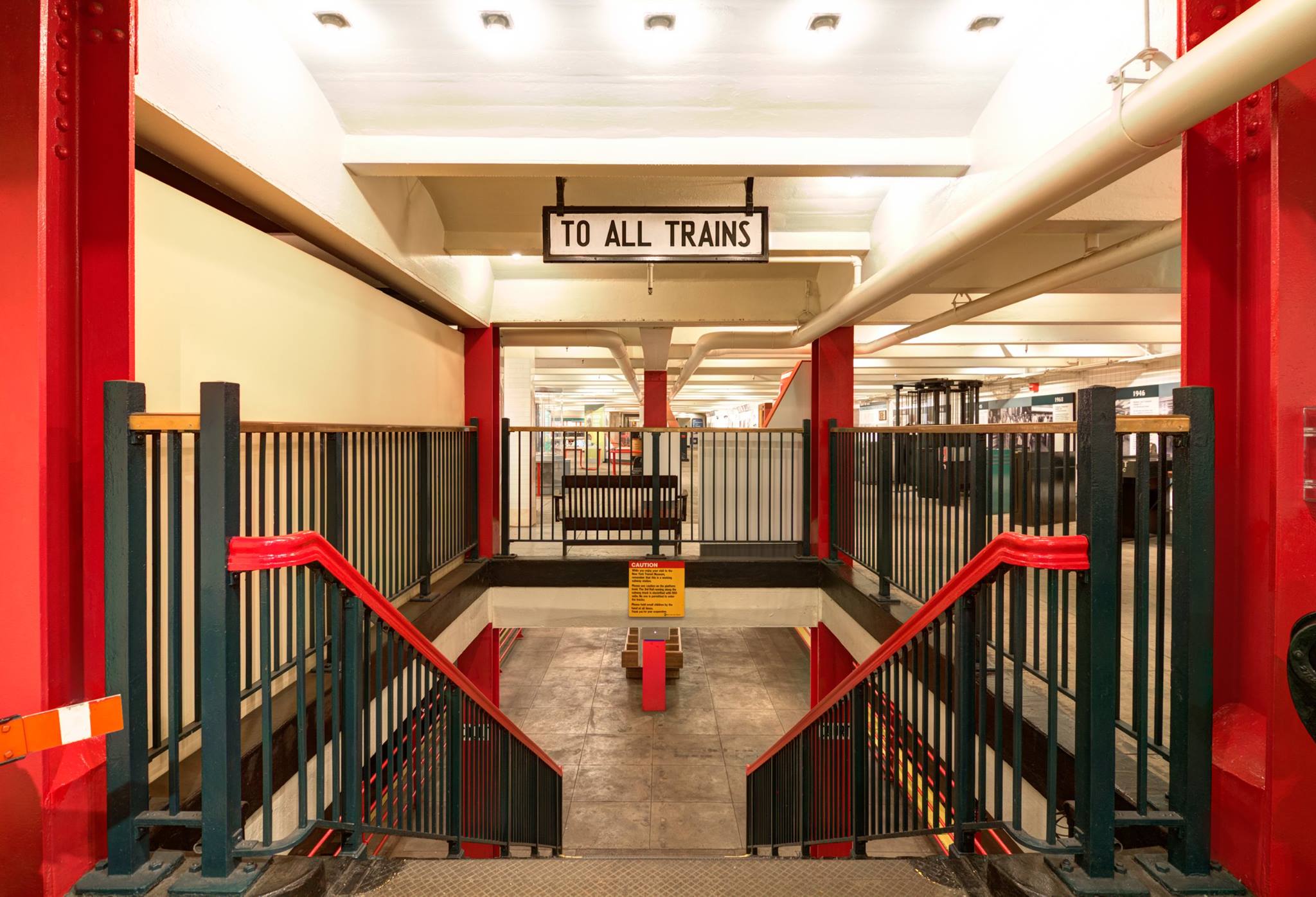 Stairs to the museum's train platform with "To All Trains" sign hanging from the ceiling.