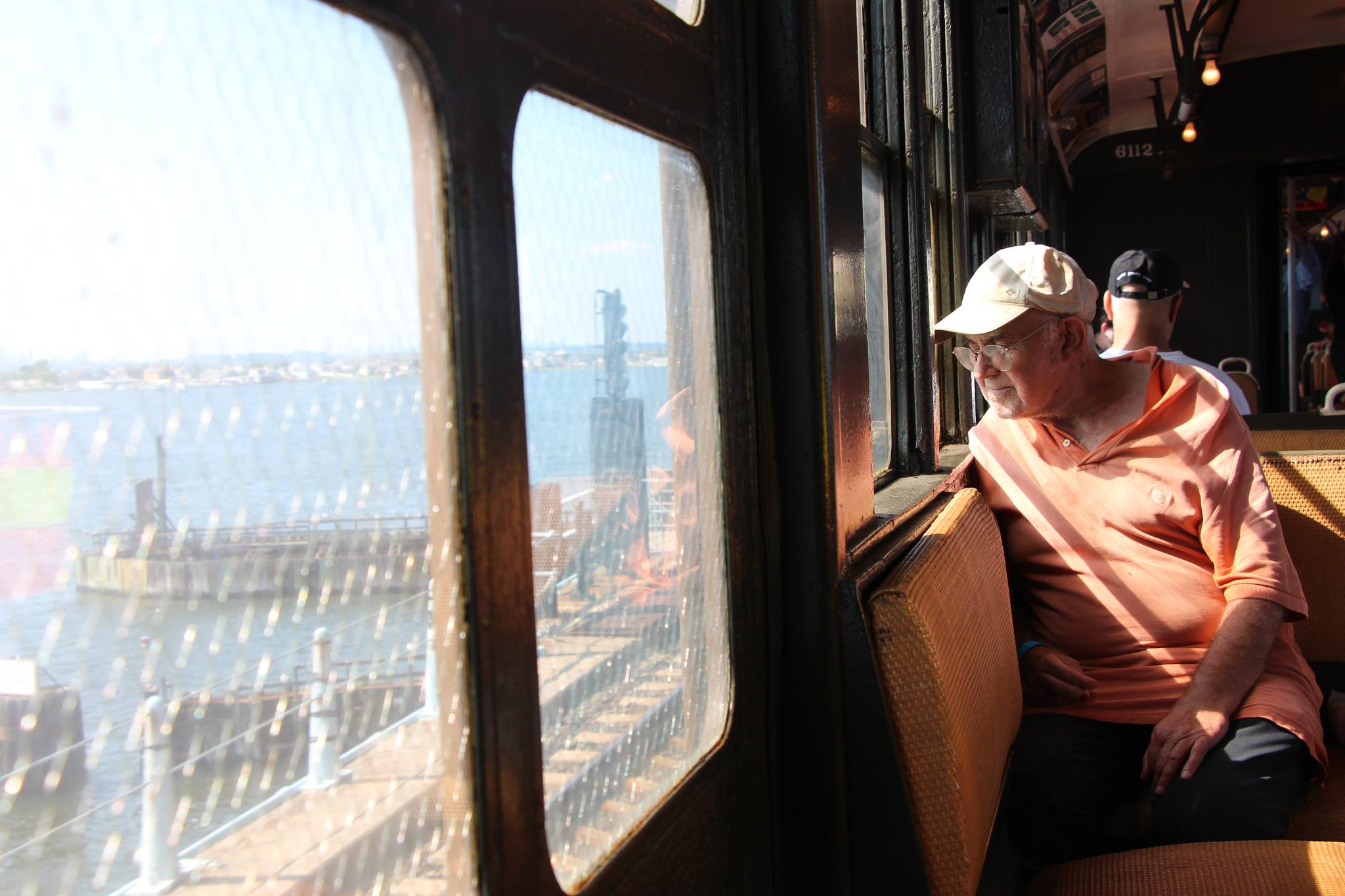 Man looking out window of vintage train car