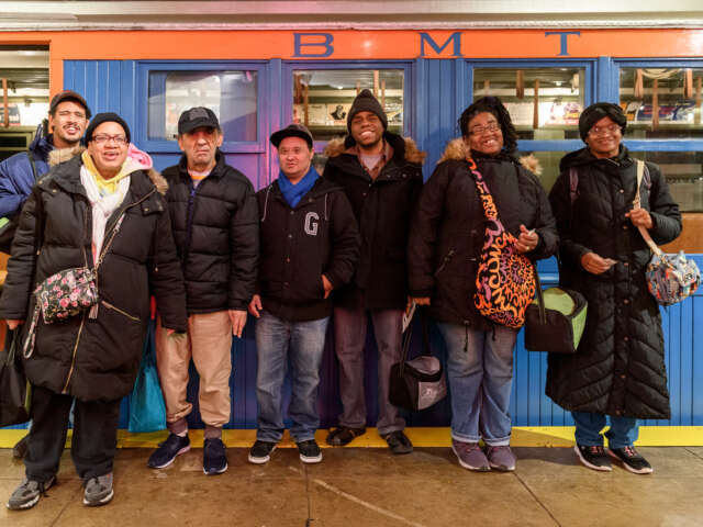 Group stands in front of vintage train at Day Habilitation Day