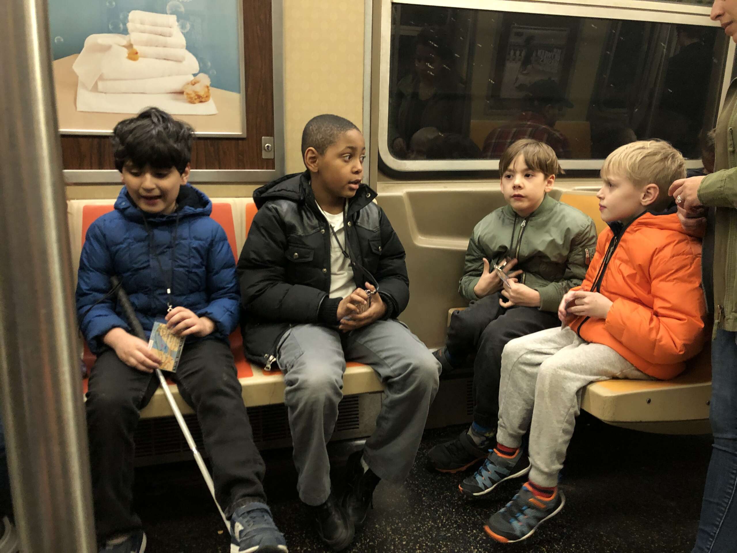 Four Subway Sleuths students on a subway car.