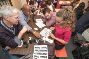 Transit trivia team seats around a table working on an activity together.