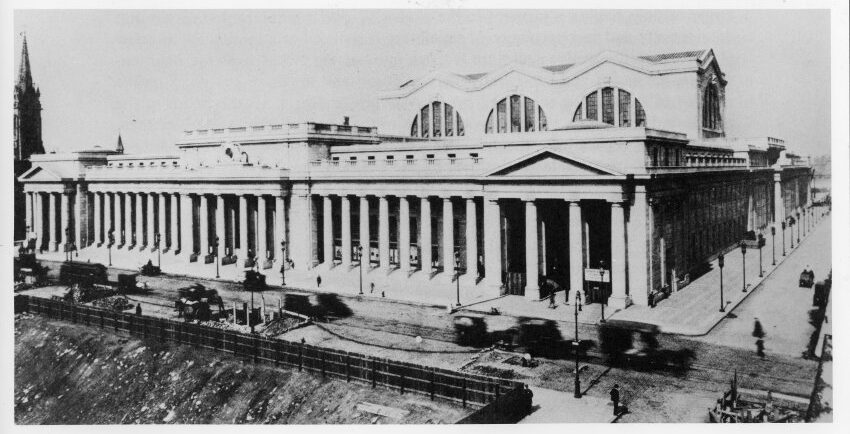 Pennsylvania Station with horse and gas powered vehicles in front. Photograph from around 1910.