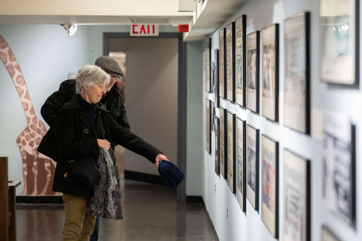 Couple viewing Shining a Light on The Subway Sun: The Art of Fred G. Cooper and Amelia Opdyke Jones