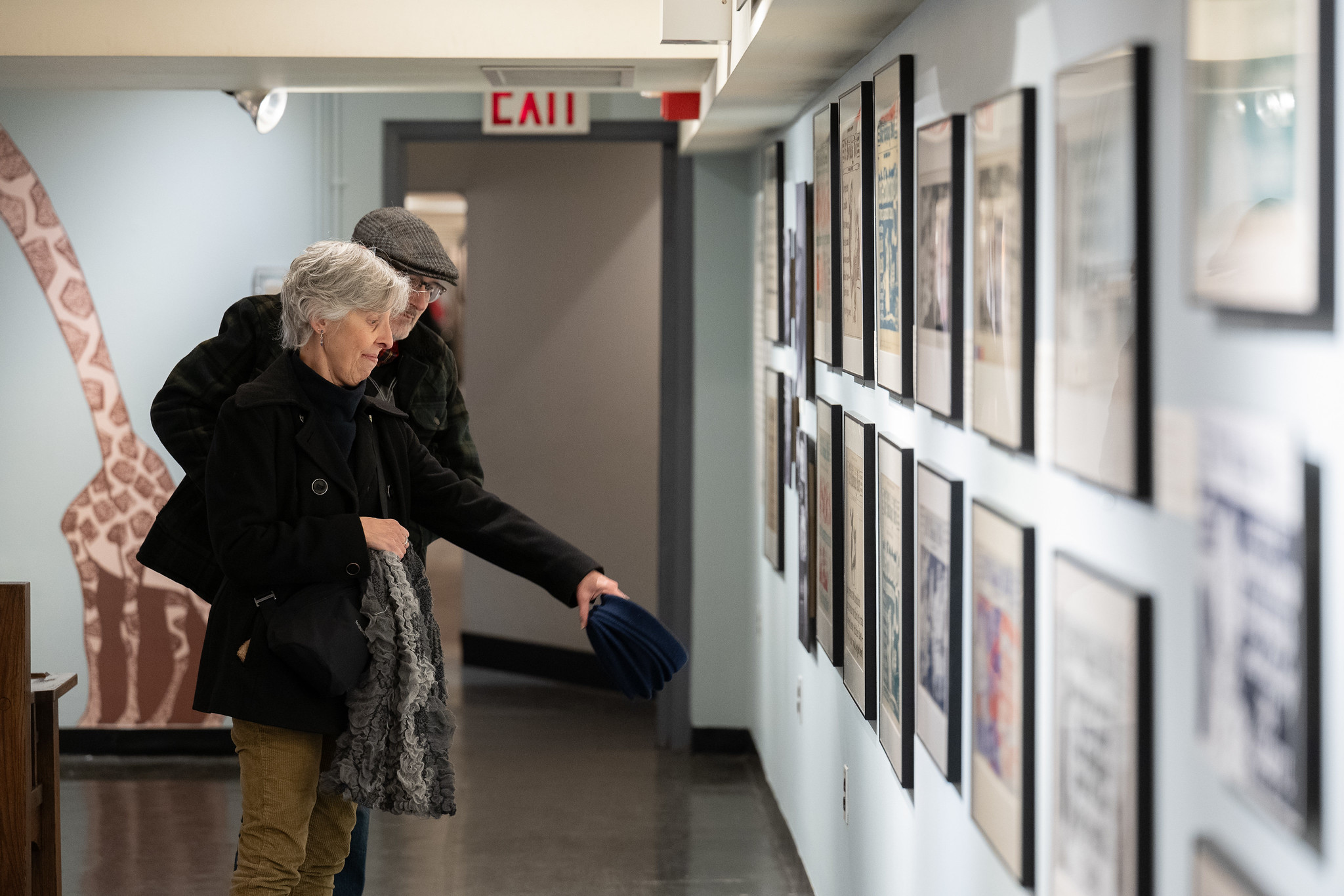 Couple viewing Shining a Light on The Subway Sun: The Art of Fred G. Cooper and Amelia Opdyke Jones