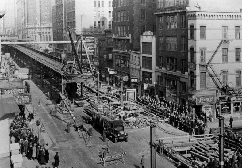 An aerial view of the dismantling of the Sixth Avenue El and the building of the 6th Avenue IND Subway Line on 6th Avenue at 30th Street.