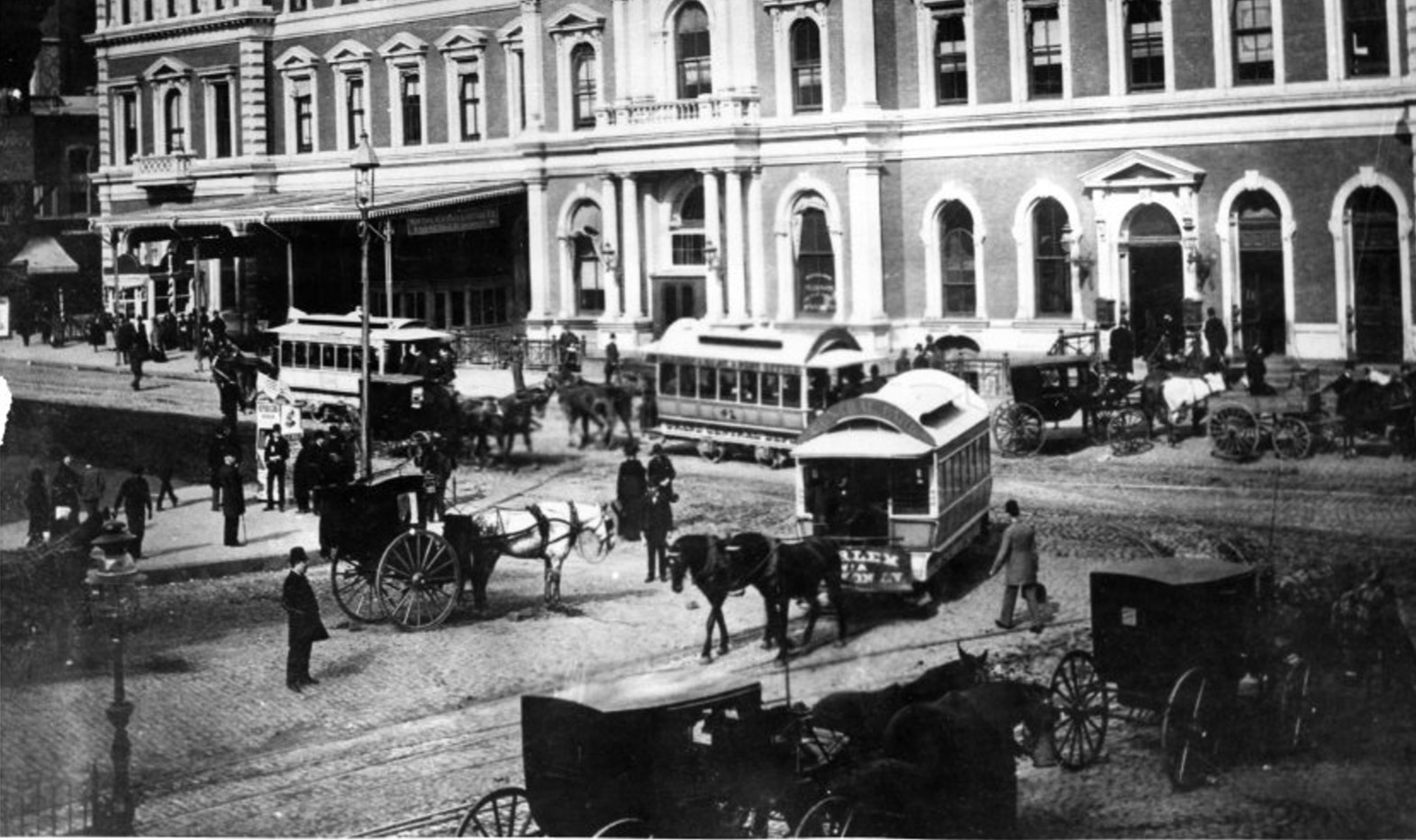 Facade of the Grand Central Depot and trolley lines along 42nd Street and Fourth Avenue.