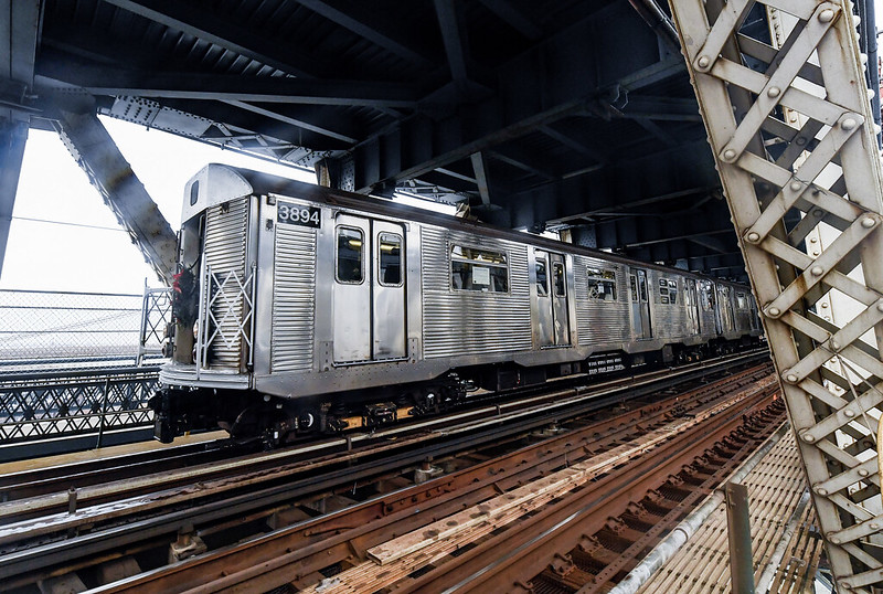 Brightliner subway car travels over bridge.