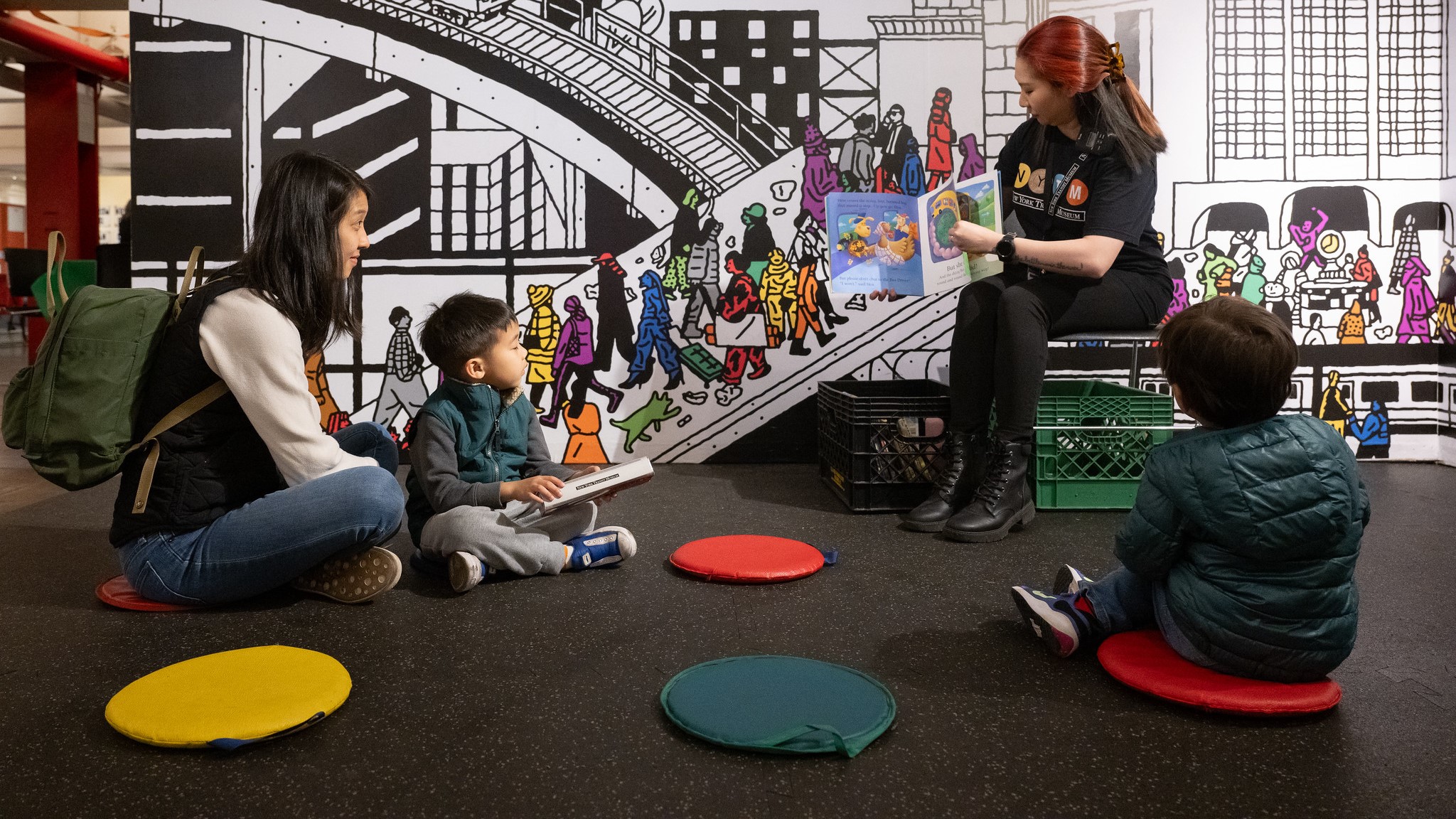 Woman reads story to children at the transit museum