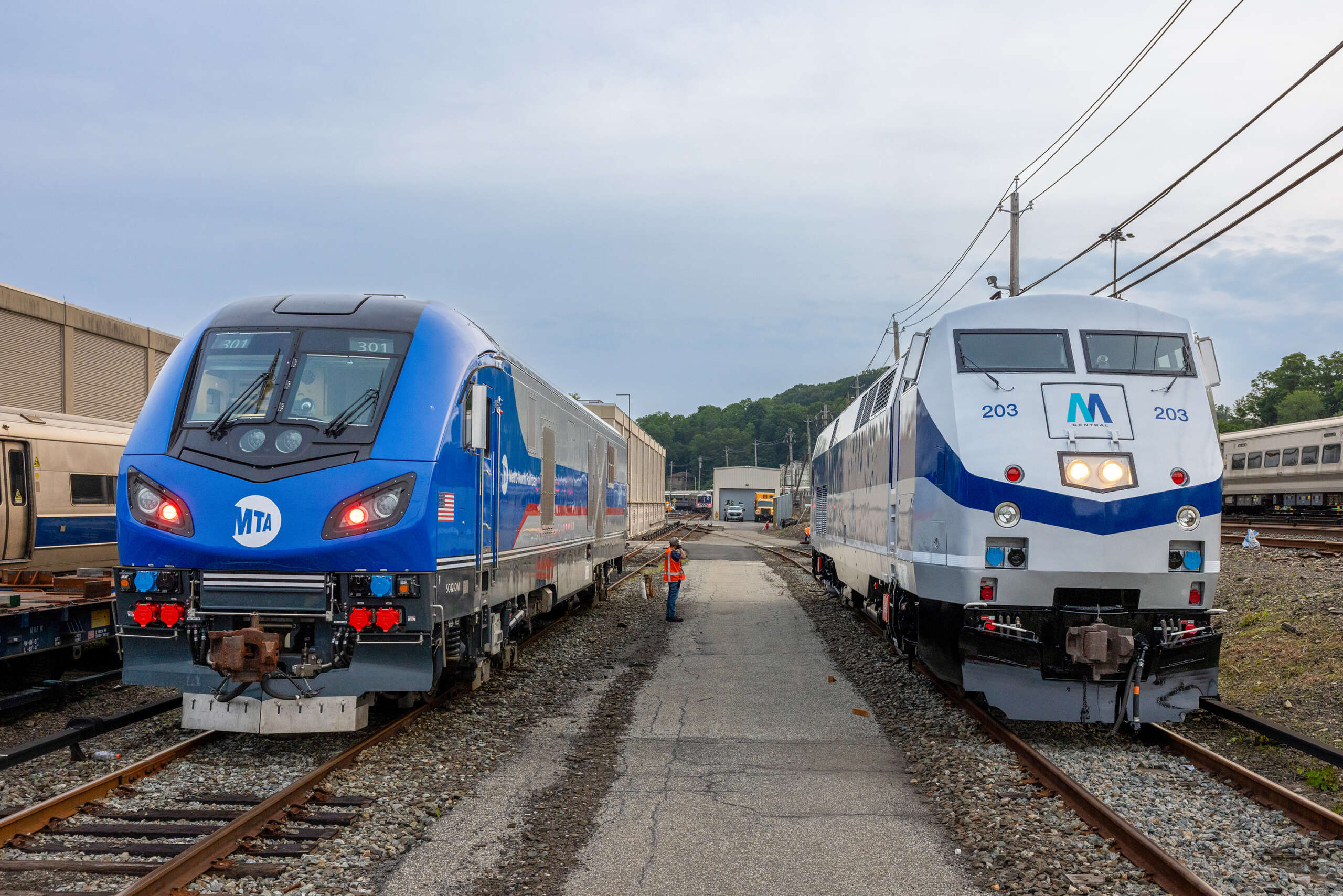 The M Central unit (203) poses next to a brand new Charger locomotive at North White Plains