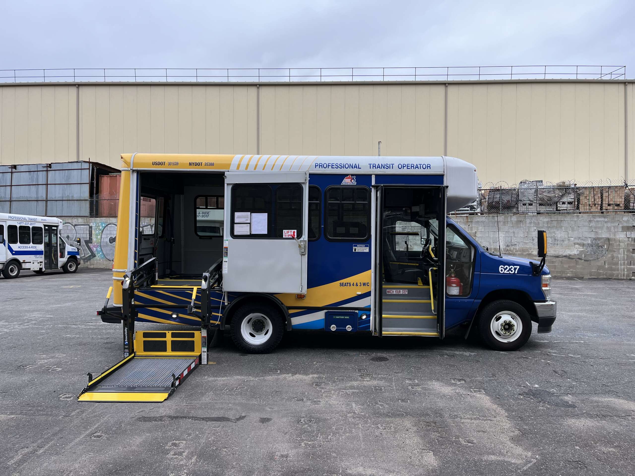 A yellow and blue van with a wheelchair accessible side cut out