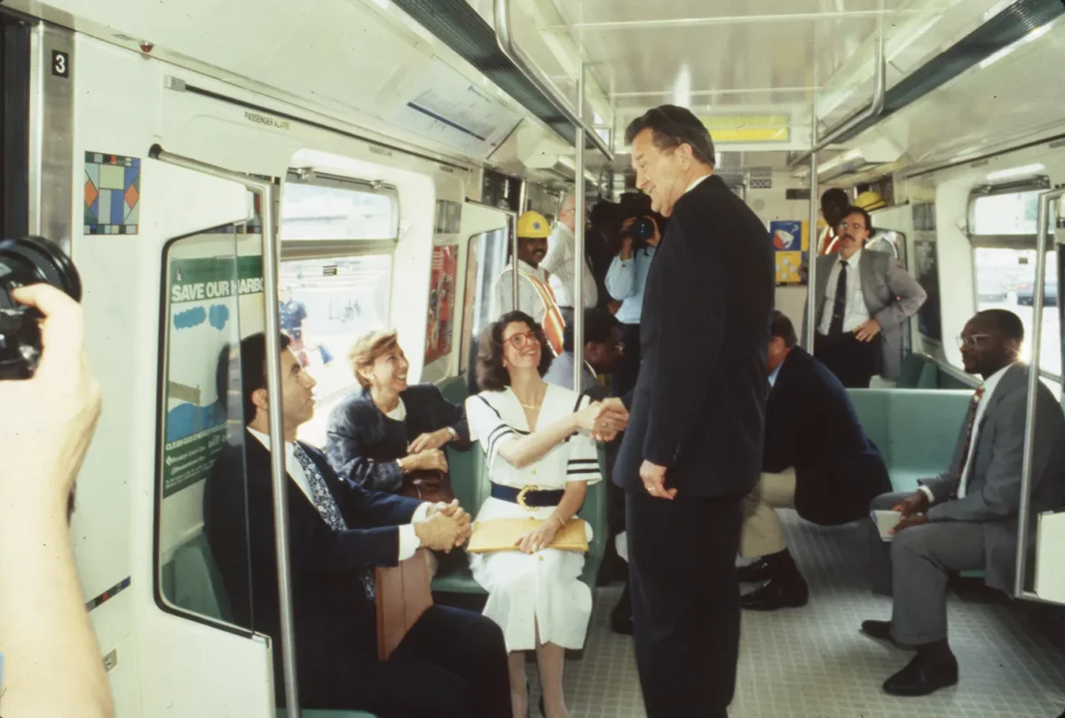 Man shaking hands with passengers on an R110B
