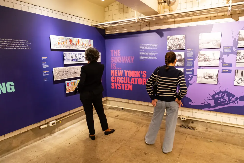 Man and woman viewing exhibit at the New York Transit Museum