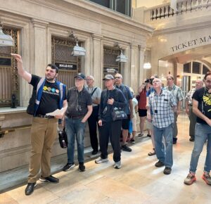 Tour guide points out features of Grand Central Great Hall to guests.