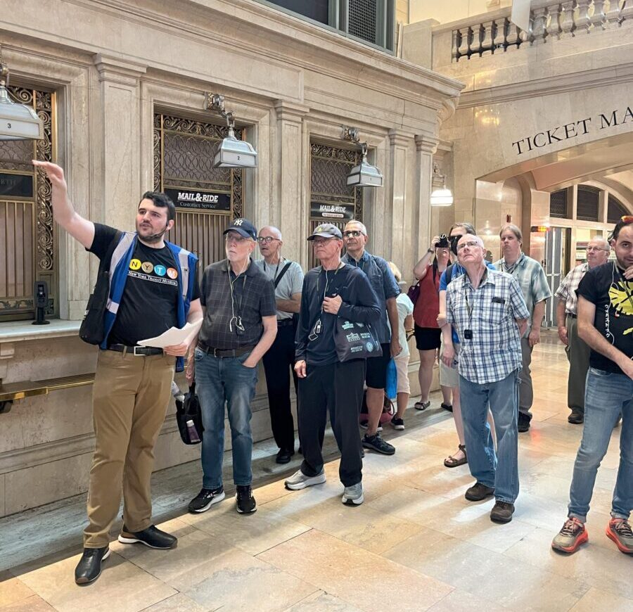 Tour guide points out features of Grand Central Great Hall to guests.