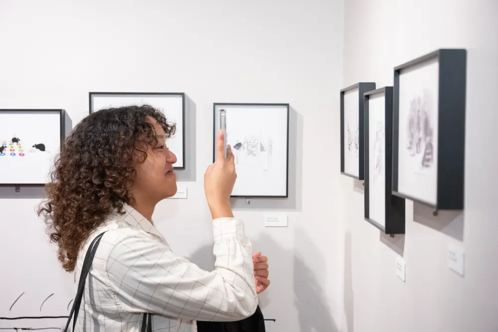 Woman takes photo of art on the wall