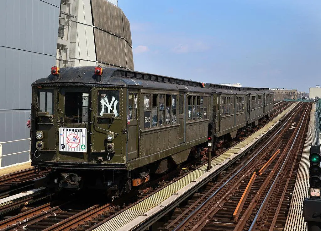 A Lo-V train on an elevated track in front of Yankee Stadium