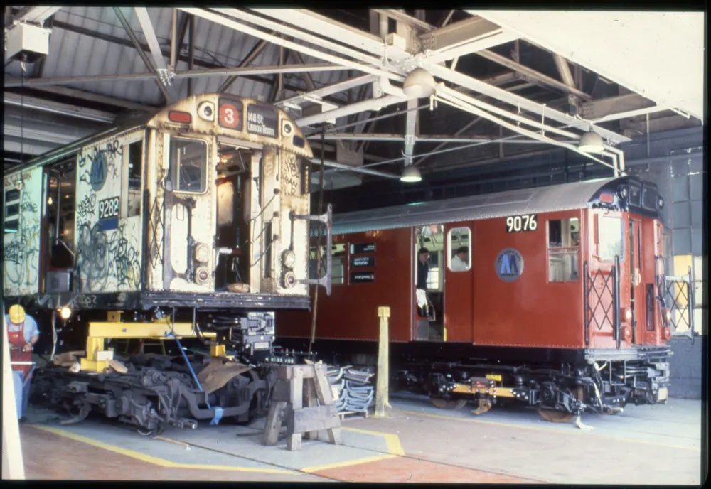 2 train cars in a maintenance garage - R-33s before and after overhaul, 1988