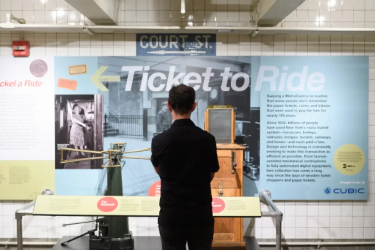 Man standing in front of the Ticket To Ride exhibit