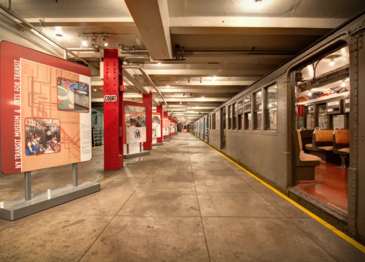 Transit Museum platform with red columns, exhibit installations, and vintage train