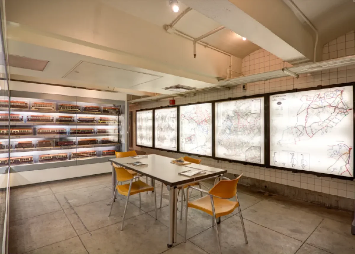 Table and chairs with trolley models and backlit maps of trolley system