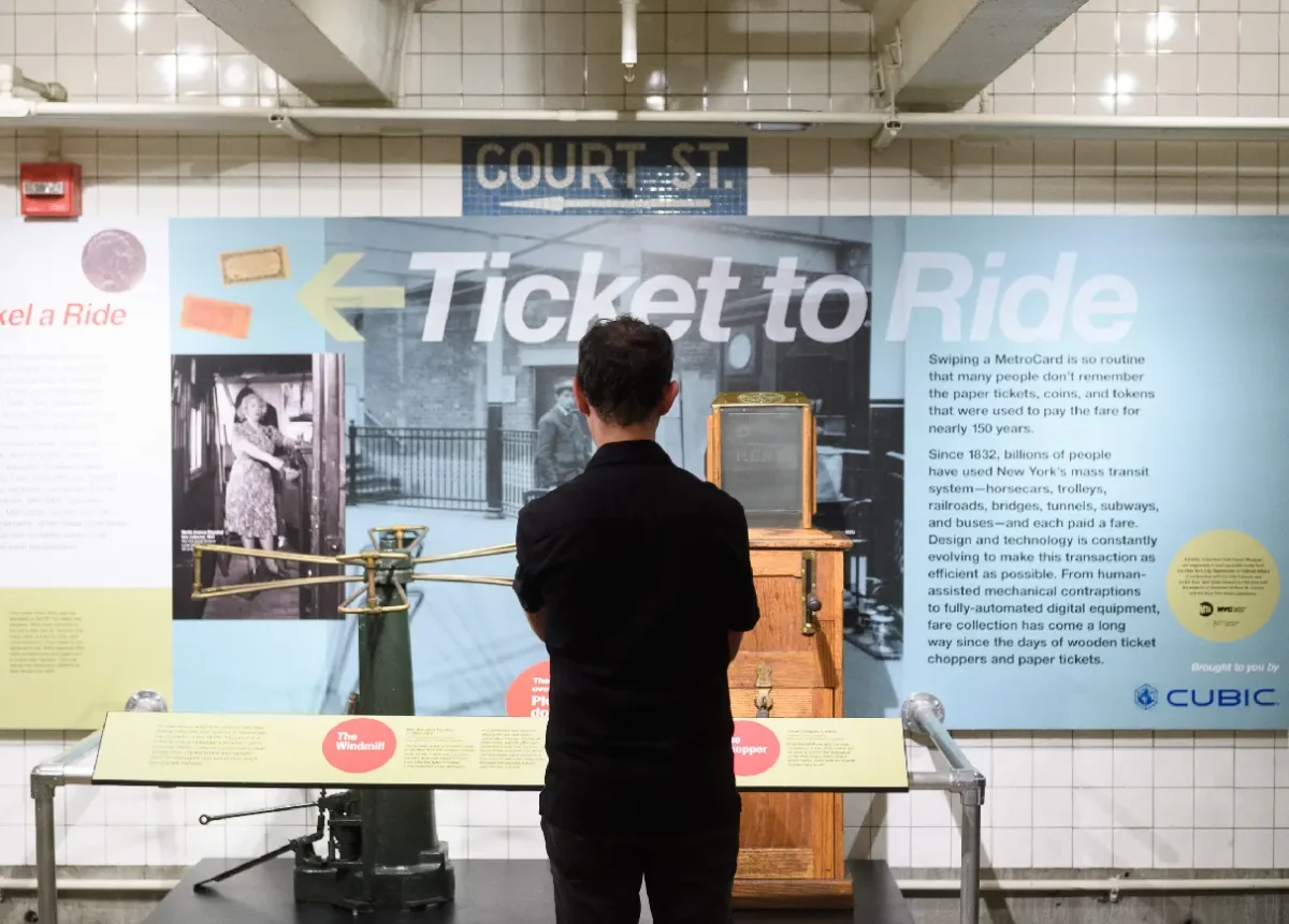Man standing in front of the Ticket To Ride exhibit