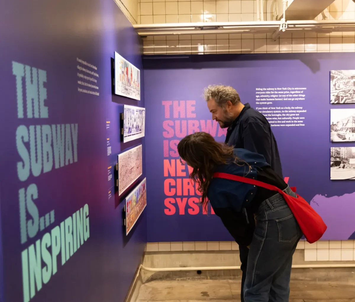 Man and woman viewing The Subway Is exhibit at the New York Transit Museum