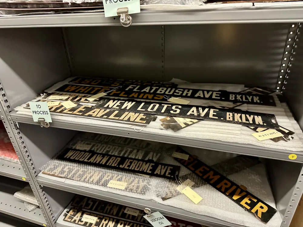 Various street signs on curatorial shelf