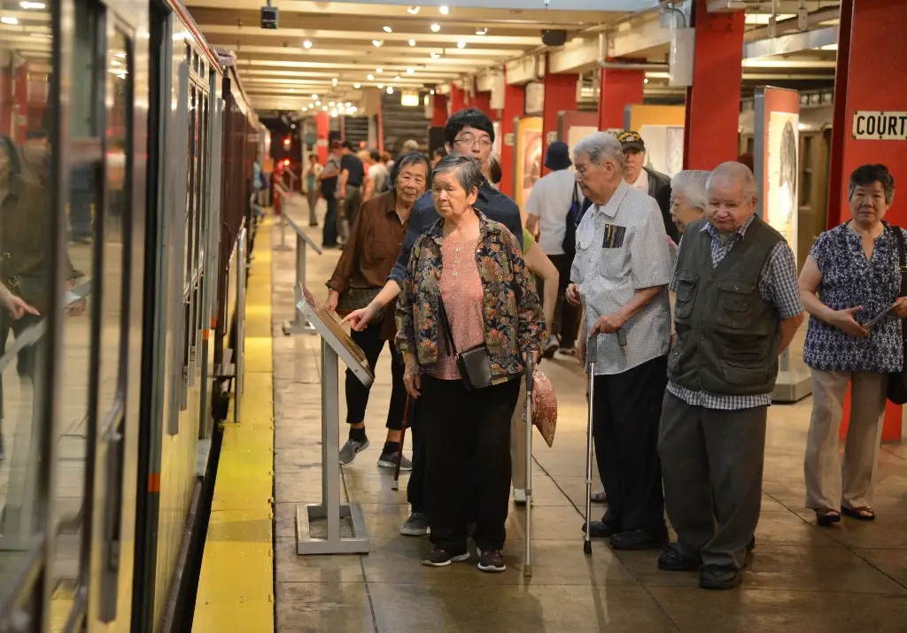 Group of seniors on the museum platform including some using canes