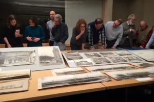 Group examining archival materials at a members only program