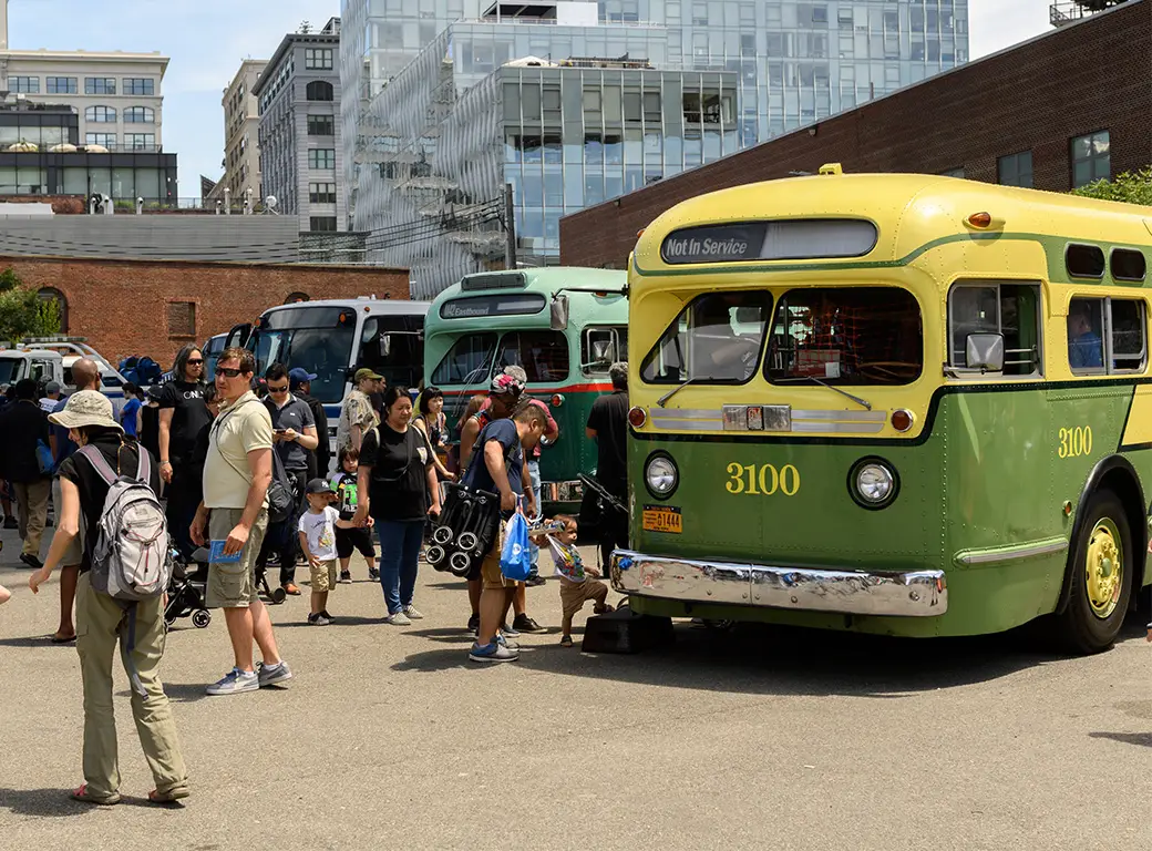 People exploring vintage buses