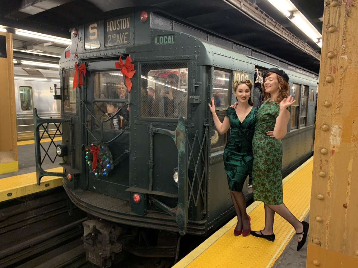 Two women in front of Holiday Nostalgia Train