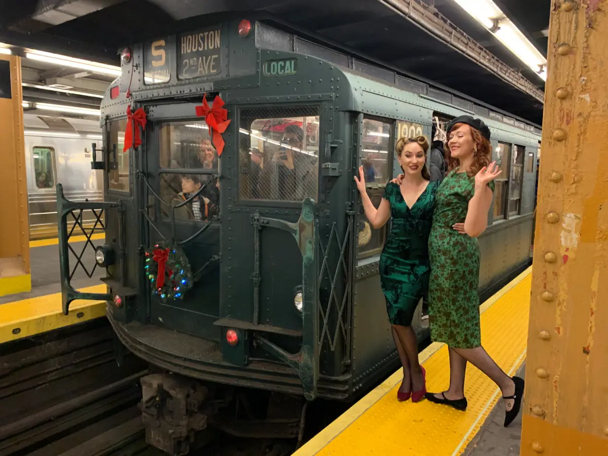 Two riders standing in front of Holiday Nostalgia Train
