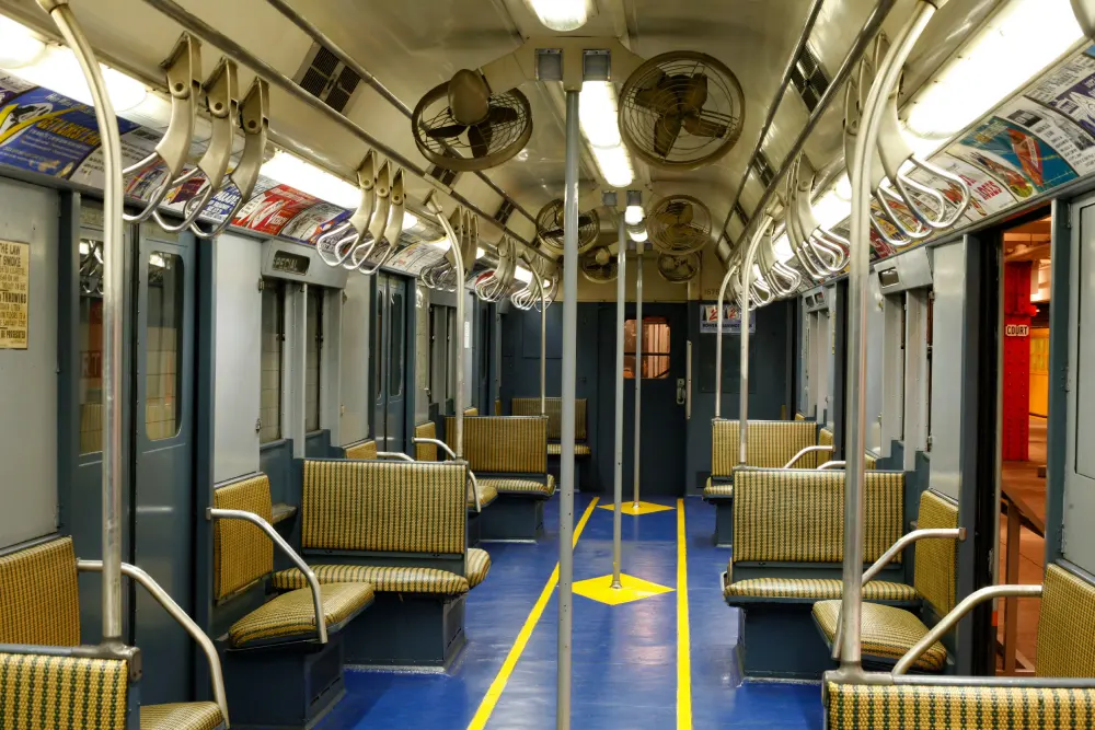 Interior of a vintage subway car with blue and yellow floors