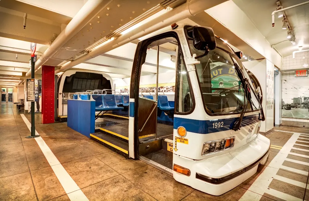 Blue and white bus with stairs to seating on view at the Transit Museum