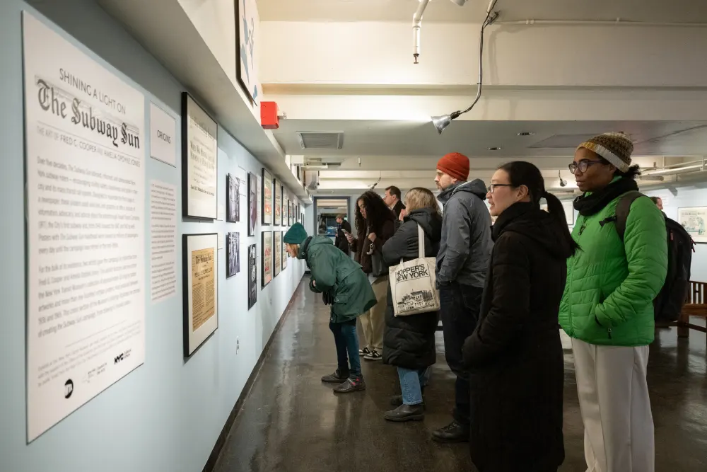 Group of adults viewing artwork on the wall in Subway Sun exhibit at the museum
