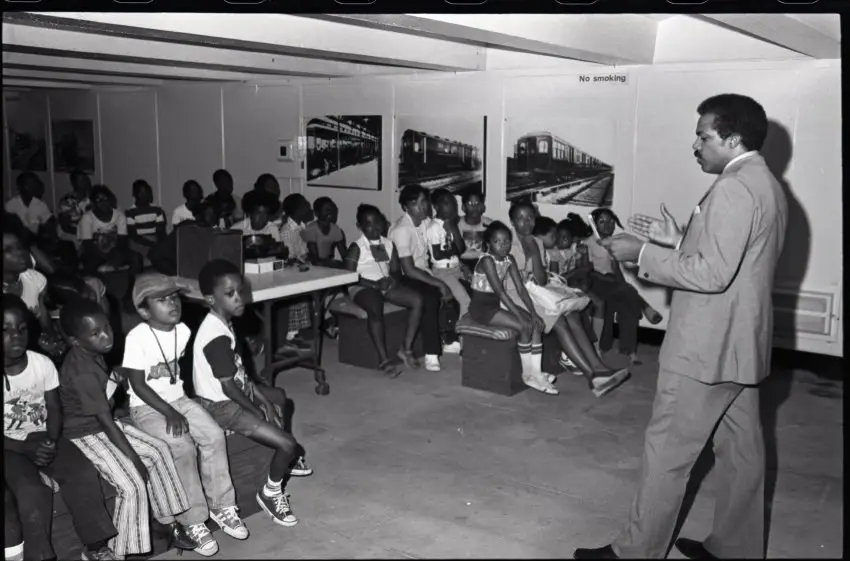 Volunteer Speaking to Group of Children