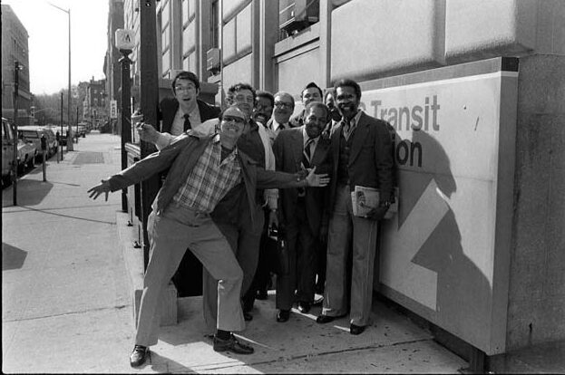 Group standing in front of the original transit exhibit in 1976