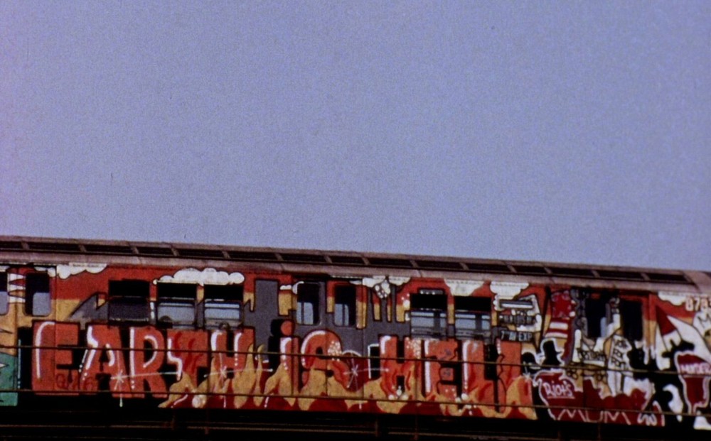 A train with colorful graffiti.